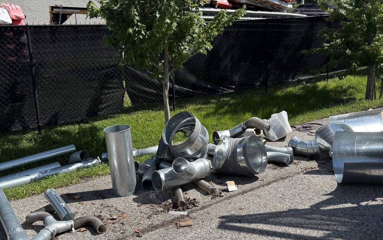 Junk removal before in Cape Coral FL — metal ductwork piled for haul-away by J Property Services